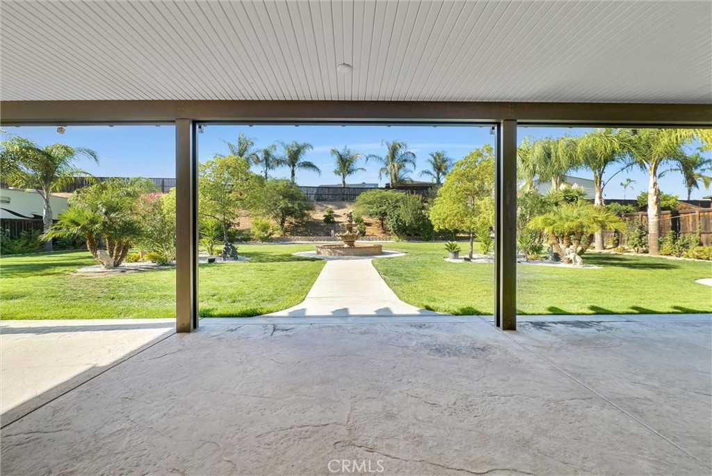 **PRICE IMPROVEMENT**
Welcome to this beautifully landscaped home in the sought-after community of Boulder Springs. Bordering Riverside and Lake Matthews, with shopping in South Corona a few minutes away, this home offers comfort, functionality and space to spread out, both inside and out. Step inside to a large formal living and dining area that flows seamlessly into the inviting family room and spacious kitchen—both offering tranquil views of the backyard. The kitchen is a chef’s delight with granite countertops, an oversized island, stainless steel appliances, and ample cabinetry.
The primary suite features a luxurious en-suite with dual vanities, a jetted tub, separate shower, private water closet, and an expansive walk-in closet. Four additional bedrooms, each with sleek mirrored closet doors, enhance both light and space. Generously sized rooms offer versatile options, including the potential for a dedicated home office on the main floor. The upstairs laundry room adds ease and efficiency to your daily routine.
Step into the backyard and discover a lush, meticulously maintained garden designed for both relaxation and entertaining. Enjoy a soothing water fountain, custom built-in BBQ with speakers, and an impressive array of mature fruit trees—orange, apple, peach, lemon, lime, Asian pear, plum, guava, apricot, and pomegranate—providing beauty and a bountiful harvest right at home.
Additional highlights include a spacious 4-car tandem garage with custom cabinetry and epoxy flooring, RV parking, and a wide driveway for easy accessibility.