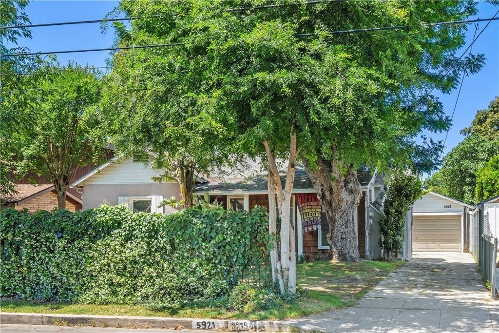This charming two-unit property (each with its own address: 5919 + 5921) is nestled in one of the most desirable parts of Valley Glen, just blocks away from Sherman Oaks. It's an ideal opportunity for a variety of living situations—live in one unit and rent out the other, use it as a full investment property, or create a perfect multi-generational living setup. The front home has 883 sqft and is brimming with character and vintage charm. With two bedrooms and one bathroom, it offers a picturesque aesthetic. The living room features high cathedral ceilings adorned with wood beams, a fireplace framed by sconces, and a stained glass window above the mantel. The cozy dining room includes built-in cabinets with glass doors, and the home includes some hardwood floors and moldings throughout. Both the kitchen and bathroom have some tile detailing. The kitchen—with an oversized window—overlooks the charming yard and connects to a laundry area with washer and dryer. The front house opens to a private, fenced yard that feels like a secret garden. Its filled with an impressive variety of vegetables and fruit trees, including Meyer lemon, lime, blood orange and pomegranate trees, along with snap peas, asparagus, corn, tomatoes, raspberries, plums, avocados and blackberries. Landscaping includes red roses, wisteria, calla lilies, lavender, clementines, and white bird of paradise. Jasmine and morning glory climb the fence line, while wine grapes-Chardonnay, Zinfandel, and Cabernet—add to the idyllic setting. At the rear of the property sits a newer one-bedroom, one-bathroom home that is completely private and has 547 sqft. Its been completely remodeled and includes a sleek kitchen with newer appliances, custom cabinetry, and granite countertops. The bathroom features a large glass-enclosed shower with a tiled interior and built-in seating bench. Outside, the private Zen garden and patio are fully gated. Whether you’re looking for a charming personal residence with rental income, a smart investment property, or a comfortable solution for extended family living, this exceptional property checks all the boxes.