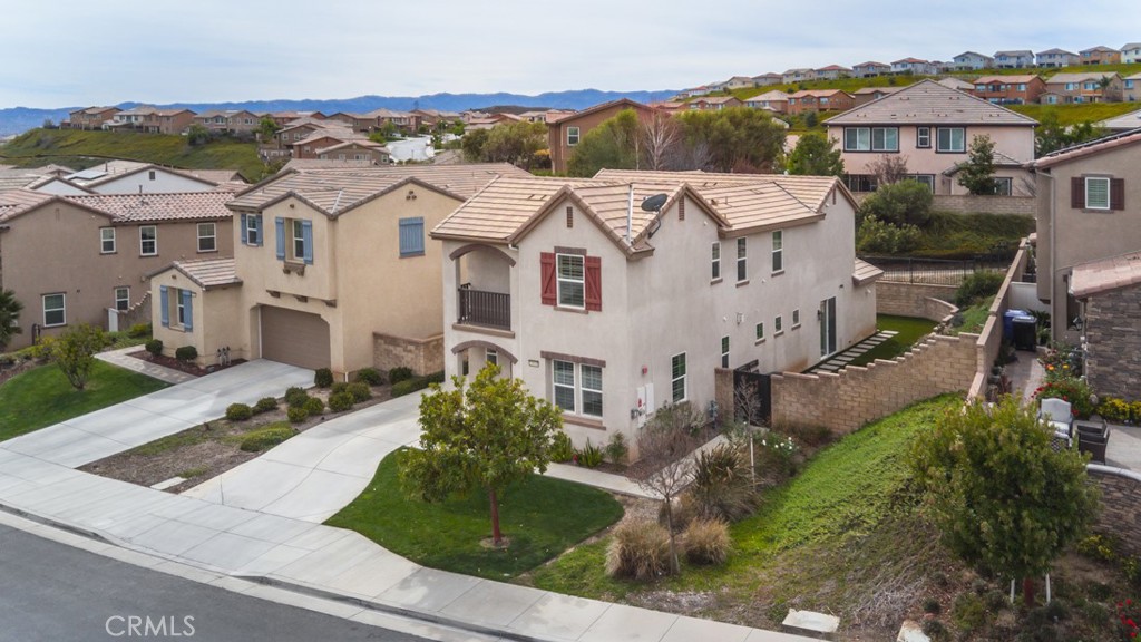 Welcome to this turn-key home located behind the gates of Valencia West Hills gated community, with all the upgrades you will find in a model home! Step into this elegant 4-bedroom, 3-bathroom residence and experience luxury, comfort, and convenience. As you enter the foyer, you are greeted by high ceilings and beautiful laminate floors that invite you in and lead the way into the family room where one can sit by the fireplace or watch a movie. The chef’s kitchen features granite countertops, custom cabinetry, and stainless-steel appliances that effortlessly combine form and function. A generous island provides ample room for meal preparation and casual dining, while the adjacent dining is perfect for entertaining. Retreat upstairs to find your sanctuary, the primary suite! It offers private spa-like bathroom with dual vanities, an oversized soaking tub, a separate walk-in shower and walk in closet. Each additional bedroom was designed with ample space, ensuring comfort and privacy for family and guests. One secondary bedroom is conveniently located downstairs, perfect for guests or multi-generational living. The outdoor space is equally enchanting, featuring your private in-ground newer spa/jacuzzi and high-quality turf side yard that offers a tranquil setting for outdoor enjoyment. This home offers not just a beautiful living space but also 3 Community Resort-Style Pools and Spas, Clubhouse and Award-Winning Schools. This is more than just a home; it’s a lifestyle. Don’t miss your chance to make this dream home yours. Schedule a private showing today.