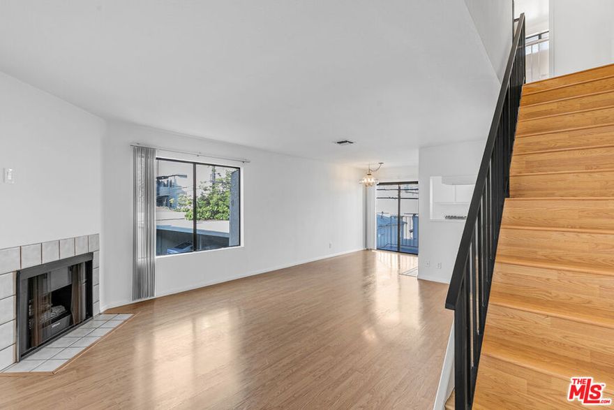 This sunny, multi-level three-bedroom is ready for its next story. Tucked in a small, charming building on Purdue, it's perfectly positioned between everything you love on the Westside -- just a few minutes to Sawtelle, Santa Monica, and Mar Vista, with super easy access to the 10 and 405. Inside, it's a happy blend of cozy and spacious. Think wood floors, a gas fireplace, and a layout that makes perfect sense. One bedroom and full bath are downstairs for ideal separation, and two more are upstairs, each with its own bathroom and leafy views. One even has a balcony for morning coffee or late-night stargazing. The kitchen is big and functional with a gas stove, full-size fridge, and dishwasher, plus a great little patio just outside the sliding doors. Cook, hang, open the door for a breeze... it's a good vibe. The whole place feels bright, private, and homey in the best way. Laundry is on-site and parking is included. This one's got just the right mix of space, style, and location. Come take a peek! You'll know if it's right when you walk in.