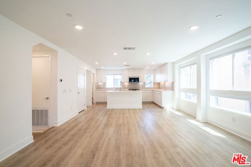 Beautiful gated end-unit townhome in Valley Village! This 3-story residence offers 3 bedrooms plus a versatile flex room and 3.5 baths on a charming tree-lined street. The first floor includes a private ensuite bedroom, while the second floor features an open-concept layout with a modern kitchen, functional island, walk-in pantry, and spacious living room surrounded by three walls of windows. A private balcony with a natural gas BBQ hookup makes entertaining easy. Hardwood floors flow throughout, and the discreet laundry area keeps the space organized. Upstairs, additional bedrooms and a flex room provide a private retreat, ideal for an office, gym, or playroom. Smart-home features include a Ring doorbell, keyless entry, and a 2-car side-by-side attached garage pre-wired for EV charging. Conveniently located near the 170, 405, and 101 freeways and just minutes from Universal CityWalk, dining, and shopping, this home offers the perfect combination of comfort, privacy, and convenience.