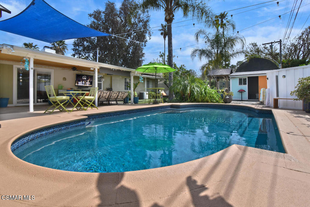 Green Certified Mid Century Modern Oasis.(Solar Panels | car charger | LG energy efficient appliances | outdoor Solar Hot shower | tankless water heater | smart soil water sensor watering system) Welcome to 7761 Balcom Avenue, a mid-century modern oasis where timeless design meets contemporary luxury. This 3-bedroom, 2-bathroom retreat has been thoughtfully upgraded with sophisticated details and Green Certified with several energy-efficient enhancements, including Solarvine solar panels. Inside, a striking custom slatted wood ceiling sets the stage for an inviting atmosphere. Both bathrooms have been stylishly updated with modern tile, built-in cabinetry, and spa-inspired fixtures. Solid core interior doors add a touch of refinement, while smart upgrades throughout ensure effortless living. Step outside to an entertainer's dream, where a converted saltwater pool resurfaced with Pebble Tech awaits, then wash off in the solar powered outdoor hot shower. The pool house offers a cozy escape with seating, a TV, and towel lockers, while Bluetooth-connectable outdoor speakers, a projector, and ambient lighting set the mood for unforgettable gatherings. Two luxurious cabanas, an outdoor kitchen with a propane grill and fridge, and vibrant lemon, lime, and orange trees make this space as functional as it is stunning. A secured garage with an epoxy-finished floor, new cabinetry, a coded side gate, and a comprehensive security system with 2 weeks of video storage ensure both style and peace of mind. Move-in ready and designed for those who appreciate elegance, comfort, and energy efficiency, This is more than a home, it's a curated lifestyle, a sanctuary of style, comfort, and efficiency. Move-in ready and waiting for you, this one-of-a-kind mid-century modern oasis is a rare gem. Don't just live, live beautifully!