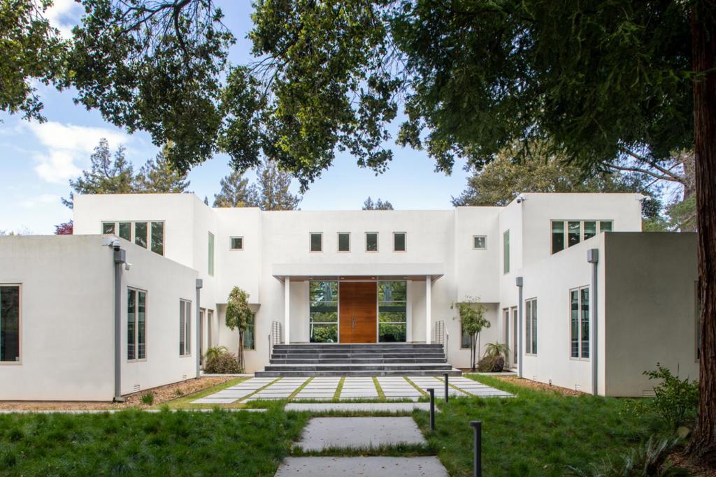 Significantly renovated in 2013, this 3-level contemporary masterpiece offers symmetry and balance. Hickory floors in every room, open concept design, incredible light, fitness center, theatre, steam shower, library, and office. Lutron + Control4 state-of-the-art home automation system. 6 bedrooms including 2 primary suite bedrooms one of which is on the ground level. Custom made, rift-sawn oak & walnut cabinetry. Gated private grounds with vanishing pool with curbless deck surrounded by an expansive lawn. Both attached 2-car and detached 2-car garage for parking for 4 cars. Room to add an ADU.