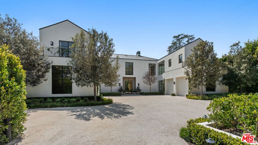 Completely secluded behind tall gates and mature trees on one of the most exclusive streets in Brentwood, an absolutely stunning property masterfully designed by a team of extraordinary designers and craftspeople, sparing no expense.  A striking warm contemporary home featuring hand-built steel doors and windows, double framed thick marmorino plaster walls and/or ceiling/walls covered in vertical grain light natural oak. Truly incredible scale, high ceilings and clean lines throughout, a gorgeous living room, paneled library/office/bar, formal dining room, and one the most spectacular kitchen/family room and breakfast rooms in town. There's a separate chef's kitchen, elevator, and full state-of-the-art smart house technology.  An ultra-luxurious primary suite with large sitting area and a jaw dropping spa-like bathroom cut from over 50 slabs of imported stone and gorgeous walk-in closets, gallery-esque hallways lead to all en-suite bedrooms with stunning baths and walk-in closets. Full professional Dolby Atmos movie theater, game room/wine tasting and cellar, bar and wellness center with gym, salon, massage, and sauna. Incredible gardens, gravel motor court, large lawns, rare specimen trees, gorgeous swimmer's pool/spa, and wonderful areas for outdoor dining and entertaining. Shown to prequalified clients only.