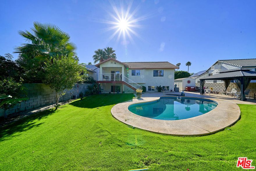 Nestled on Minerva Road in the heart of Cathedral City, this split-level home offers a comfortable and inviting living space. With a south-facing orientation and functional floor plan, the home features 4 bedrooms, 3 bathrooms, and a versatile bonus room that can serve as an office, gym, or media room. It's ideal for multigenerational households seeking flexible living options. The bonus room can serve as a private suite for grandparents or adult children, or function as a home office, gym, or media room. The kitchen has granite countertops and stainless steel appliances. The adjacent dining area opens to a deck with mountain views, perfect for enjoying your morning coffee or evening cocktails. The backyard is an entertainer's dream, with a pool and Jacuzzi, a pergola for shaded outdoor dining, and established landscaping including mature orange, tangerine, and grapefruit trees. A storage shed and 2 car garage provide ample space for all your outdoor equipment and toys. Conveniently located near schools, hiking trails, golf courses, and downtown Cathedral City's shops, restaurants, and galleries. Enjoy the Coachella Valley's festivals and events, without HOA fees or leased land .This home is situated on a street known locally as "Candy Cane Lane" for its holiday light displays each December. With generous storage, flexible living spaces, and a backyard made for hosting, this property offers a fantastic opportunity for multigenerational families seeking a home in a desirable location.