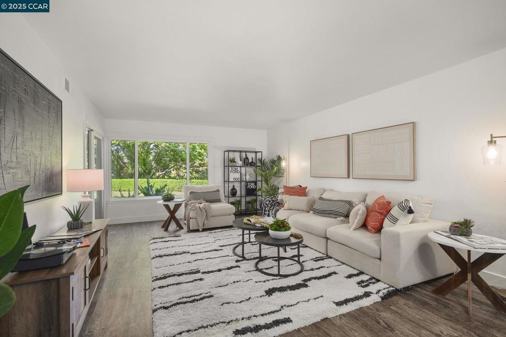 OPEN HOUSE Sunday 1:00-4:00. Beautifully renovated, ground level Mariposa model! 1,281 square feet, great room concept overlooking expansive lawns w/ filtered views of the surrounding hillsides. Luxury vinyl plank flooring throughout the property, 5” baseboards & bedrooms feature new carpeting. Spacious secondary bedroom overlooks the private courtyard entry. A full hall bath w/ walk-in shower & new clear glass, black framed shower doors. Laundry room w/ full-sized washer & dryer. King-sized primary suite's walk-through closet & vanity area features new vanity, lighting, 2 spacious wardrobe closets & allows you to enjoy the view from your spacious, level out patio w/ room for flexible furniture options. A tranquil setting to enjoy mornings & evenings outdoors. Great room also exits to patio & features a large picture window for natural light. Entertainment areas open to dining & provide connectivity to the kitchen...fully renovated w/ new cabinetry, pantries w/ pull out shelves, top-of the-line KitchenAid stainless appliances, Caesarstone countertops, recessed lighting & eat-in nook complete the story of your future home. Central heat & A/C. Detached one-car garage!!! Endless possibilities of how to enjoy this home & community, but the time is now to make this one your own!