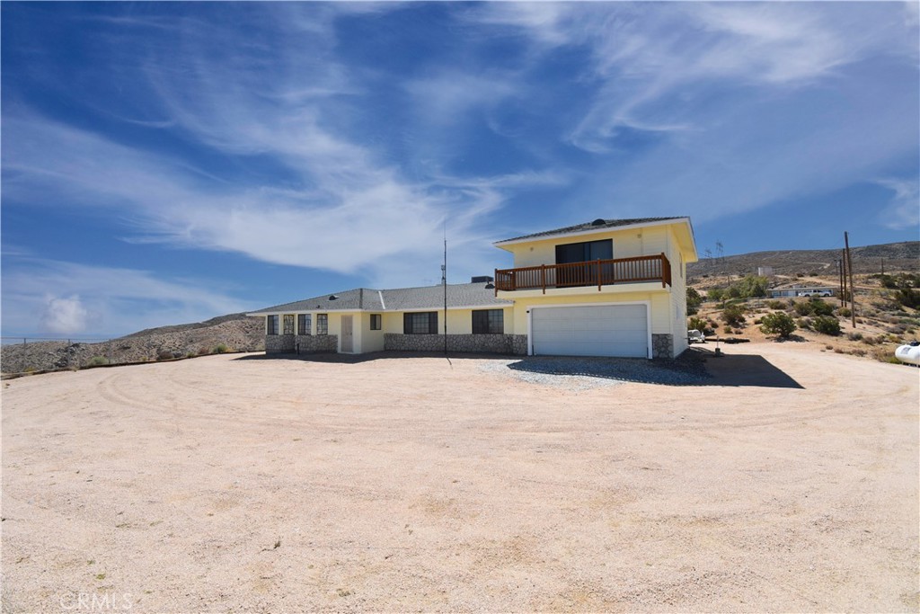 WOW! WOW! WOW! Your Expansive High Desert Retreat Awaits! Welcome to 8448 Milpas Drive, where comfort meets opportunity on nearly 5 acres of scenic Apple Valley land. This sprawling 4-bedroom, 3-bath, 3,249 sq ft home offers space, (Includes enclosed sun porch) privacy, and versatility, perfect for multi-generational living, home-based business, or simply spreading out and enjoying wide open spaces.
Inside, you will find two full master suites, ideal for guests, in-laws, or private retreats. The upstairs master is truly extraordinary, a spacious haven with its own bonus area that is perfect for a home office, workout space, or sitting area. Step out onto the private balcony and soak in breathtaking views of the Milpas Highlands, where sunrises, sunsets, and starry nights are included.
The family room invites cozy gatherings with a charming built-in wood-burning stove, while the large kitchen offers plenty of cabinetry and counter space for home-cooked meals and entertaining. Natural light fills every corner of this thoughtfully designed home.
Outside, your 4.79-acre lot is brimming with potential, RV parking, future workshop, horse setup, or even a desert garden dreamscape. There is room to roam and grow while still being just a short drive from town conveniences. Unbelievable view, definite WOW factor!
This property is a rare blend of size, flexibility, and serene surroundings, a true High Desert gem.