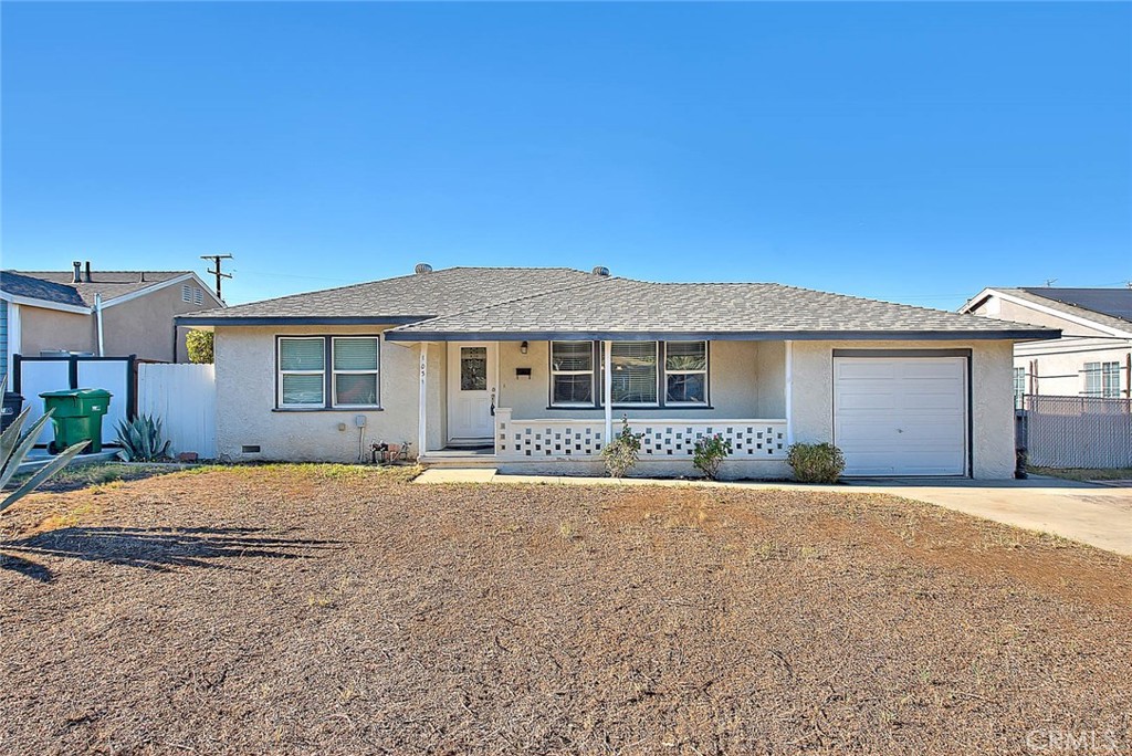 Nice Home in Corona with Three Bedrooms, Two Bathrooms and 1536 Square Feet of Living Space.  This Home Features an Upgraded Kitchen with Granite Counter Tops, Newer Cabinets, Stainless Steel Appliances Including a Gas Range, Microwave and Dishwasher.  The Kitchen Also has a Dining Space, Recessed Lighting and Pendant Lights.   Tile Flooring in the Living Room & Kitchen and Carpeting throughout the Remainder of the Home.  Central A/C and Forced Air Heating & Dual Paned Windows.  Split Floorplan Perfect for Multi-Generational Living with Two Bedrooms and One Bathroom and Then an Additional Bedroom and Bathroom with the Living Area In Between.  There is Also a Large Family Room with a Ceiling Fan and a Dual Paned Slider Door to the Rear Yard.  One Car Garage with Aluminum Roll Up Door and a Utility Room with Laundry Hookups and Built in Cabinets for Storage.  Upgraded Front Door with Glass Accents and a Large Front Porch Area.  Situated on a Large Lot with a Brick Paver Patio in Rear Yard, a Fenced Dog Run Area and 3 Fruit Trees. (Lime, Lemon and Pomegranate). Newer Composition Roof and Water Heater.