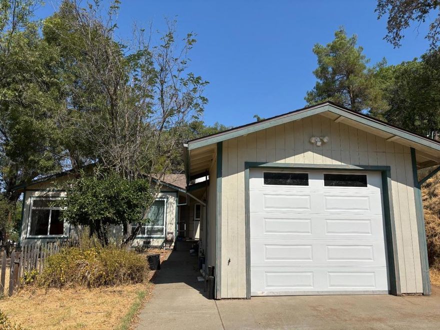 Rare opportunity to own a spacious and charming house in downtown Mariposa! Spreading at the heart of historic Mariposa, this stunning 4-bedroom, 2-bathroom home offers both modern comforts and natural beauty. The open-concept living room with carpet and natural light creates a welcoming and splendid atmosphere. The spacious bedrooms are bright and airy, showing beautiful outside views through the windows and the sliding door. The updated kitchen boasts a second dining area, plenty of wood cabinet storage, sleek countertops, and modern appliances, offering convenience and functionality. The two bathrooms with modern finishes, the detached garage with a spacious workshop inside, and the beautiful yard with plenty of patio, spaces and fruit trees, all together makes this house complacent to live and entertain. Last but not least, with walking distance to restaurants, shops and nearby lakes and trails, and 45 mins away from the breathtaking Yosemite National Parks, this house is excellent for your own primary living or for your investment in property with great potential. Don't miss this exceptional opportunity!