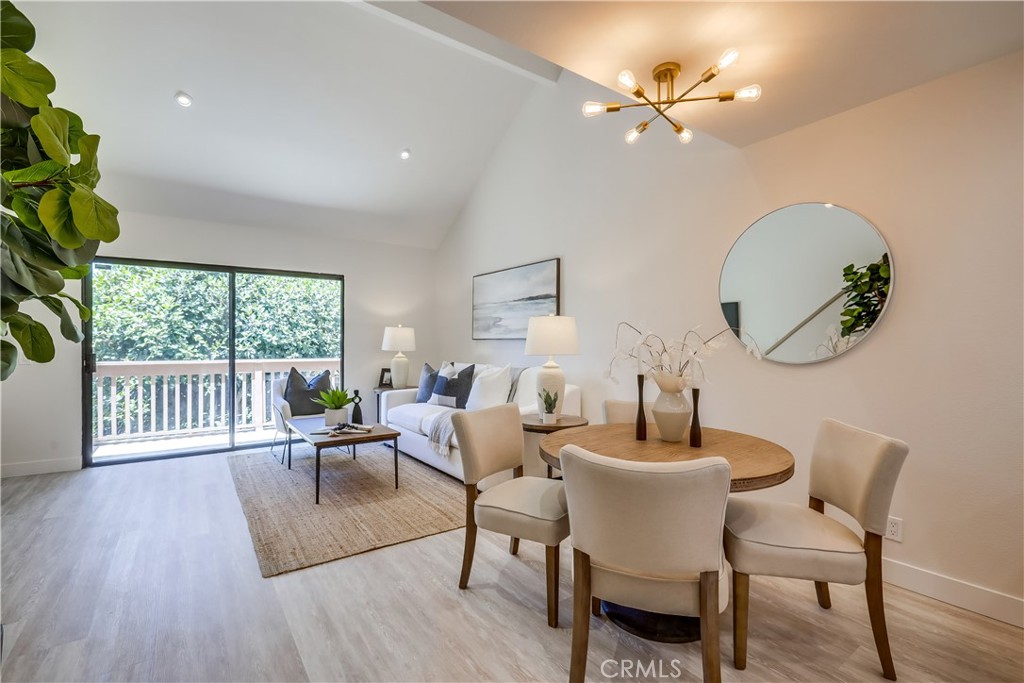 Beautifully remodeled upper-level unit boasting dazzling improvements throughout, everything new new new!!! Located in the desirable Lake Condos community at Orangetree, superbly situated just a few steps from the clubhouse, pool, tennis/pickleball courts, and boasting soothing balcony views of the bubbling pond and meandering streams, you will adore this location! Step inside and soak in the newly remodeled, freshly painted, light filled interior, blessed with an open concept floor plan, gorgeous new luxury vinyl plank floors throughout, new AC Condenser, and new custom lighting setting the stage for the perfect living environment. The living area has soaring vaulted ceilings and direct access to the private balcony overlooking the tranquil community pond and greenbelt creating an ideal indoor-outdoor living space for relaxing and with loved ones. The dining area is open to both the living room and the kitchen, providing an excellent space for entertaining. The exquisite new kitchen has been beautifully redesigned with elegant new Quartz countertops, timeless white Shaker cabinetry, new hardware and pulls, glistening subway tile backsplash, new faucet and undermount sink, new stainless-steel appliances, and a prized breakfast bar. Upstairs includes a fully enclosed bonus loft space which has a new door and closet space, vaulted ceilings, attic access, recessed lighting, and windows overlooking the living room, perfect for an executive home office, den, or 2nd bedroom. The primary bedroom on the main level includes mirrored closet doors and recessed lighting. You will fall in love with the amazing new bathroom with custom Quartz topped vanity, new faucets and fixtures, framed vanity mirror, and a gorgeous custom tiled step-in shower enclosure. This unit also boasts a dedicated laundry nook for stackable washer and dryer; plus ample storage provided in the built-in linen cupboards. This unit includes 1 dedicated assigned carport space, #166, conveniently located nearby. Community amenities include lush green spaces and walking paths, tranquil ponds and meandering streams, 2 community pools and 2 spas, Clubhouse, lighted Tennis, Pickleball, and Basketball courts, and playground. Excellent Irvine location just steps from Oak Creek Golf Club, Oak Creek Community Park, and Irvine Valley College. Close to shopping, entertainment, and dining at nearby Irvine Spectrum and Alton Square. Just minutes from Fashion Island, Newport Beach, and Corona Del Mar.