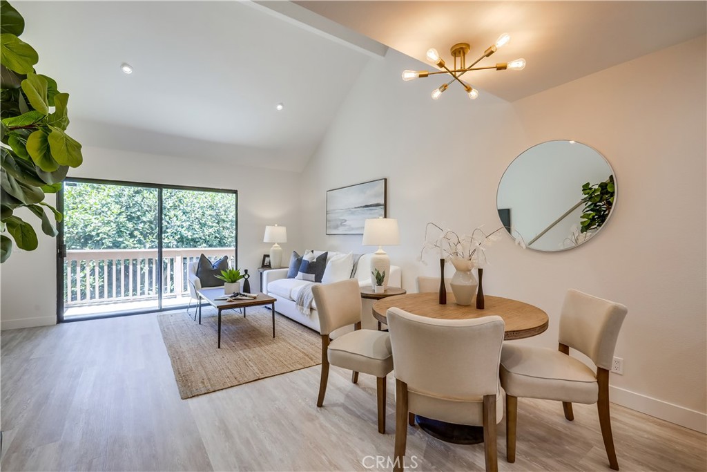 Beautifully remodeled upper-level unit boasting dazzling improvements throughout, everything new new new!!! Located in the desirable Lake Condos community at Orangetree, superbly situated just a few steps from the clubhouse, pool, tennis/pickleball courts, and boasting soothing balcony views of the bubbling pond and meandering streams, you will adore this location! Step inside and soak in the newly remodeled, freshly painted, light filled interior, blessed with an open concept floor plan, gorgeous new luxury vinyl plank floors throughout, new AC Condenser, and new custom lighting setting the stage for the perfect living environment. The living area has soaring vaulted ceilings and direct access to the private balcony overlooking the tranquil community pond and greenbelt creating an ideal indoor-outdoor living space for relaxing and with loved ones. The dining area is open to both the living room and the kitchen, providing an excellent space for entertaining. The exquisite new kitchen has been beautifully redesigned with elegant new Quartz countertops, timeless white Shaker cabinetry, new hardware and pulls, glistening subway tile backsplash, new faucet and undermount sink, new stainless-steel appliances, and a prized breakfast bar. Upstairs includes a fully enclosed bonus loft space which has a new door and closet space, vaulted ceilings, attic access, recessed lighting, and windows overlooking the living room, perfect for an executive home office, den, or 2nd bedroom. The primary bedroom on the main level includes mirrored closet doors and recessed lighting. You will fall in love with the amazing new bathroom with custom Quartz topped vanity, new faucets and fixtures, framed vanity mirror, and a gorgeous custom tiled step-in shower enclosure. This unit also boasts a dedicated laundry nook for stackable washer and dryer; plus ample storage provided in the built-in linen cupboards. This unit includes 1 dedicated assigned carport space, #166, conveniently located nearby. Community amenities include lush green spaces and walking paths, tranquil ponds and meandering streams, 2 community pools and 2 spas, Clubhouse, lighted Tennis, Pickleball, and Basketball courts, and playground. Excellent Irvine location just steps from Oak Creek Golf Club, Oak Creek Community Park, and Irvine Valley College. Close to shopping, entertainment, and dining at nearby Irvine Spectrum and Alton Square. Just minutes from Fashion Island, Newport Beach, and Corona Del Mar.