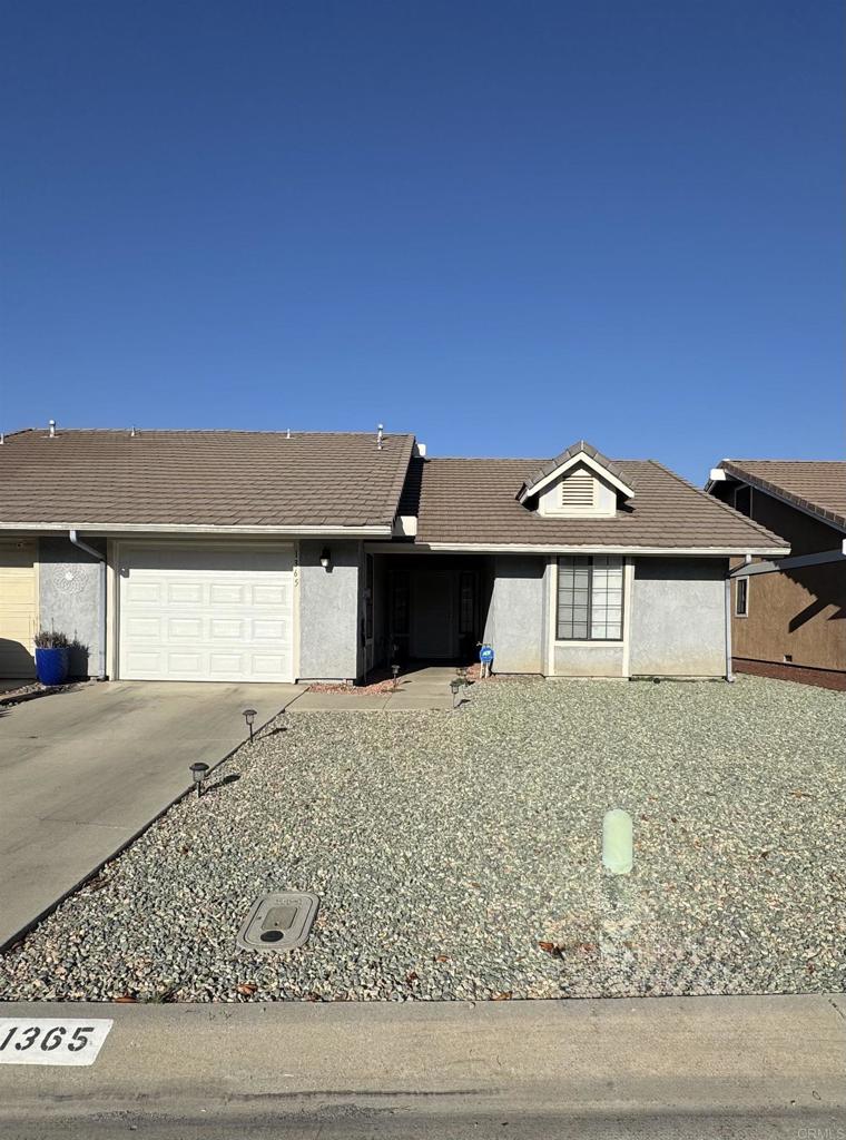Fantastic opportunity in the 55+ American Village community! This lovingly maintained 2 bed, 2 bath home offers a comfortable layout with tile and carpet flooring, a cozy fireplace, and a kitchen with a breakfast bar. The spacious primary bedroom features a large closet, and the secondary bedroom also offers ample storage. A sliding glass door leads to a private patio—perfect for relaxing or entertaining. Includes an attached 1-car garage and low-maintenance yards. Community amenities include two clubhouses, walking paths, and picnic areas. Conveniently located near shopping, dining, post office, banks, and just a short drive to a local casino! Agent is related to seller.