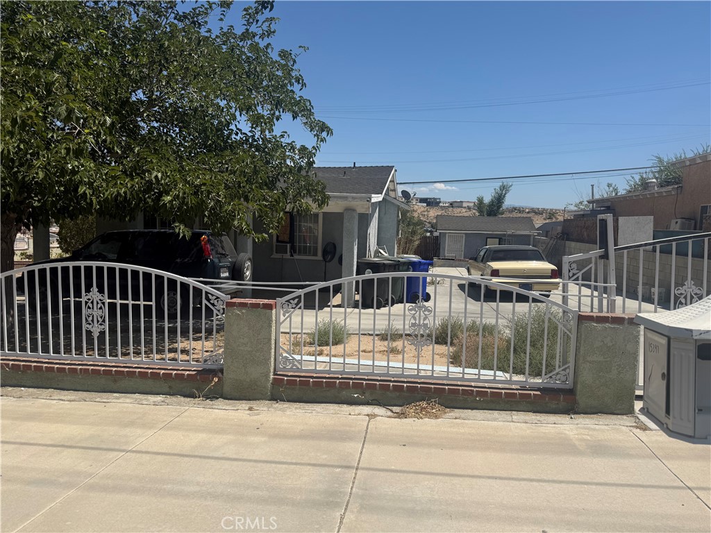 Investor Income -Cash- 2 bed, 1 bath home on a spacious corner lot featuring a storage shed and a fully fenced yard with wrought iron accents.