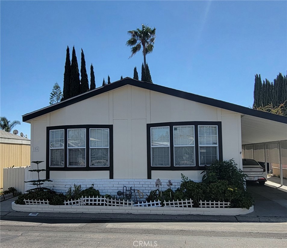 Welcome to this beautifully maintained 4 bedroom, 2 bathroom manufactured home located in the well-established Rio Vista Mobile Estates of Anaheim. Offering approximately 1,680 square feet of living space, the layout provides both function and comfort for everyday life. The home features wood flooring throughout all living areas, including the bedrooms, and is filled with natural light by a skylight and large windows. The kitchen includes granite countertops and ample cabinet storage. The spacious primary bedroom has a large bathroom with a garden tub. All additional bedrooms are comfortably sized with their own closets. Fresh exterior paint gives the home a clean, updated look. Outside, you'll find a side yard, storage shed, and a covered carport that can accommodate up to three vehicles. Residents have access to amenities such as a pool, jacuzzi, and a playground. Centrally situated with convenient access to both the 91 and 57 freeways, the home is just minutes from shopping, dining, schools, and iconic attractions like Disneyland, the Honda Center, and Angel Stadium. Don't miss the opportunity to make this turnkey property your next home!