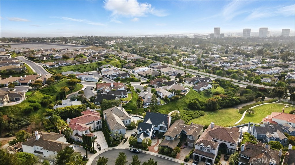 Welcome to 7 Belmont in Newport Beach.This exceptional property is located at the end of a quiet cul-de-sac within the prestigious gated community of Harbor Hills. The homesite was originally selected for its prime location and elevated position, offering unobstructed views of the Newport Beach skyline and glimpses of the ocean. These views are beautifully preserved by the expansive green park that stretches below the home, ensuring privacy and open space.
The residence spans approximately 4,543 square feet and features four spacious bedrooms, each with its own en-suite bathroom. The primary suite is highlighted by a luxurious dual bathroom configuration. A stylish powder room is also located on the main level for guests.
Additional features include laundry rooms on both levels, a three-car garage, and a generous kitchen with semi-formal dining, complemented by a separate dining area off the great room. This layout flows seamlessly to a large patio, perfect for enjoying the expansive scenery.
The home has undergone significant upgrades this year, including a new standing seam metal roof, remodeled bathrooms, updated flooring throughout, and a freshly painted exterior and interior—making it both beautifully modernized and move-in ready.