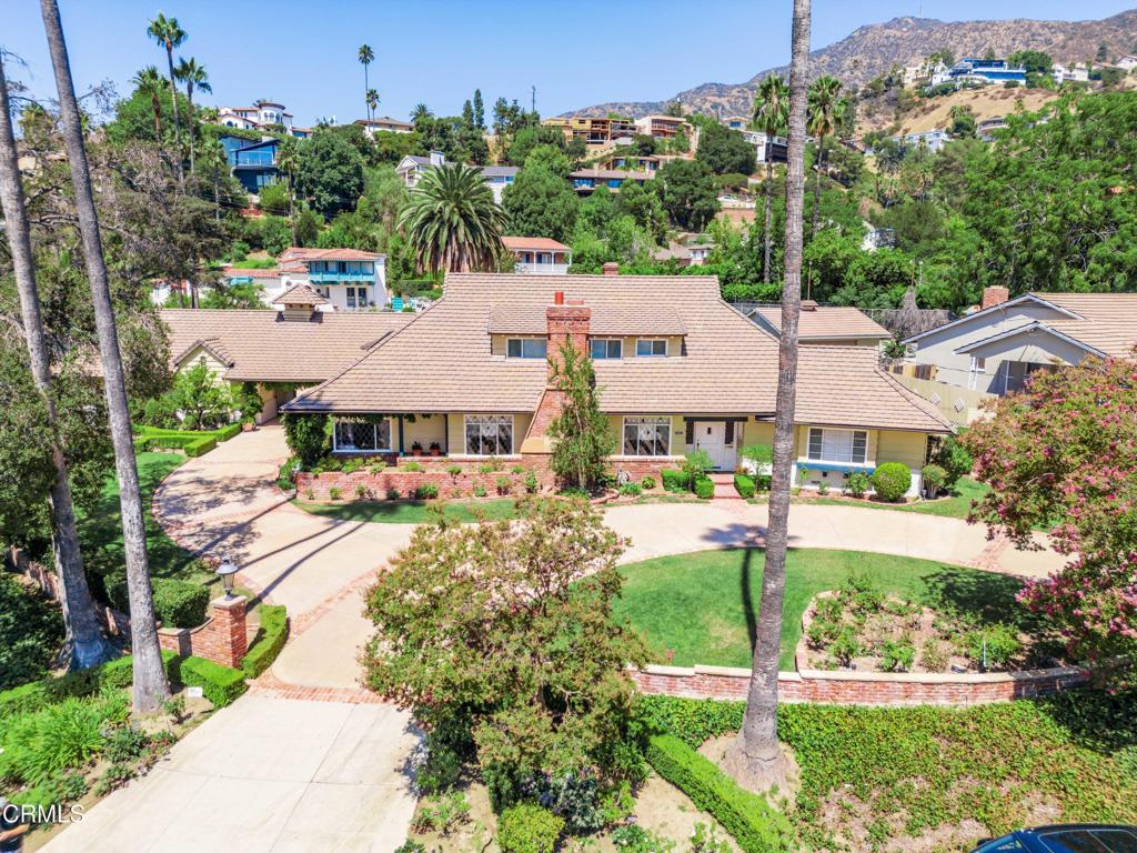 Welcome to 301 Cumberland Road, a rare storybook estate in Glendale's coveted Cumberland neighborhood. This 5-bedroom, 4.5-bathroom residence offers nearly 4,900 SF of living space on a beautifully landscaped half-acre corner lot. A circular driveway framed by manicured hedges leads to a timeless two-story home filled with natural light, hardwood floors, two fireplaces, and custom leaded glass windows. The chef's kitchen features Sub-Zero refrigeration, indoor grill, custom cabinetry, and a breakfast nook. A spacious laundry/utility room with garden views adds convenience. Outdoors, enjoy a private retreat with a sparkling pool, outdoor bathroom and changing room, koi pond, bird bath, and lush mature landscaping. Additional highlights include a 3-car garage, central A/C, and impeccable pride of ownership throughout. Located just minutes from Kenneth Village, parks, shops, and top-rated schools. A rare opportunity to own one of Glendale's most charming and well-maintained homes. Shown by private appointment only.