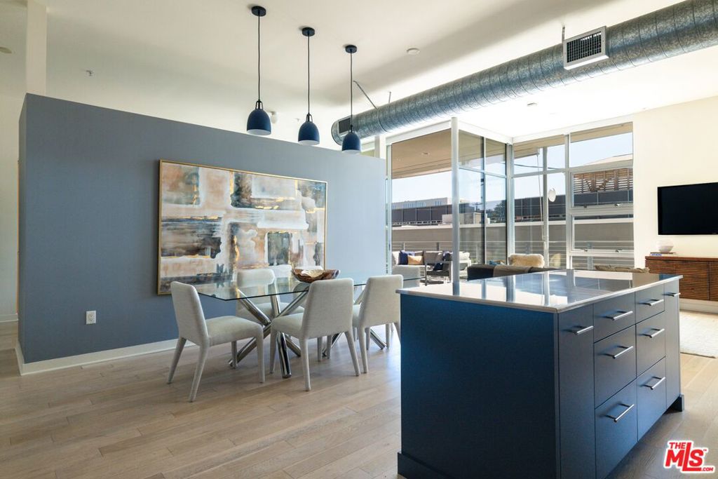 Experience the perfect blend of modern design and creative energy at Gallery Lofts, located in the heart of the vibrant Marina Arts District. Currently confirgured as a spacious 2-bedroom, 2-bathroom second-floor loft-style home which showcases south-facing views, soaring ceilings, dramatic floor-to-ceiling windows, and oversized Fleetwood sliding doors that flood the space with natural light and fresh coastal breezes.  Step inside to an open-concept layout that balances style and functionality. The sleek kitchen is equipped with stainless steel appliances ideal for culinary inspiration or everyday dining. A generous private patio seamlessly extends the living area outdoors, perfect for morning coffee or relaxing evenings. The primary suite provides a peaceful retreat with a spacious walk-in closet and a spa-inspired bathroom featuring a soaking tub and separate glass shower. Additional highlights include automated window shades, central A/C and heat, a tankless water heater, in-unit laundry, and 2-car tandem parking with exclusive-use EV charging pre-wiring, plus ample guest parking.  Set within a beautifully landscaped community, Gallery Lofts offers residents access to a tranquil outdoor lounge, complete with BBQ grills, a welcoming space to entertain, mingle with your neighbors or unwind under the stars. Located just minutes from Venice Beach, Abbot Kinney, and Playa Vista, this home is surrounded by Marina del Rey's best lifestyle amenities: bike paths, boutique shopping, local theaters, dining hotspots, and daily conveniences. This is modern coastal living at its finest, offering a rare opportunity to enjoy the best of both urban energy and seaside serenity.