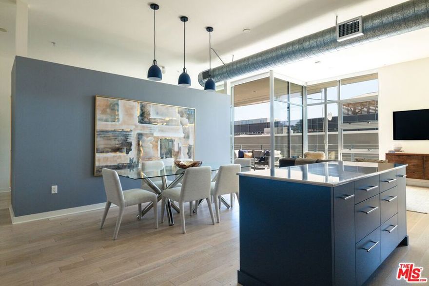 Experience the perfect blend of modern design and creative energy at Gallery Lofts, located in the heart of the vibrant Marina Arts District. Currently confirgured as a spacious 2-bedroom, 2-bathroom second-floor loft-style home which showcases south-facing views, soaring ceilings, dramatic floor-to-ceiling windows, and oversized Fleetwood sliding doors that flood the space with natural light and fresh coastal breezes.  Step inside to an open-concept layout that balances style and functionality. The sleek kitchen is equipped with stainless steel appliances ideal for culinary inspiration or everyday dining. A generous private patio seamlessly extends the living area outdoors, perfect for morning coffee or relaxing evenings. The primary suite provides a peaceful retreat with a spacious walk-in closet and a spa-inspired bathroom featuring a soaking tub and separate glass shower. Additional highlights include automated window shades, central A/C and heat, a tankless water heater, in-unit laundry, and 2-car tandem parking with exclusive-use EV charging pre-wiring, plus ample guest parking.  Set within a beautifully landscaped community, Gallery Lofts offers residents access to a tranquil outdoor lounge, complete with BBQ grills, a welcoming space to entertain, mingle with your neighbors or unwind under the stars. Located just minutes from Venice Beach, Abbot Kinney, and Playa Vista, this home is surrounded by Marina del Rey's best lifestyle amenities: bike paths, boutique shopping, local theaters, dining hotspots, and daily conveniences. This is modern coastal living at its finest, offering a rare opportunity to enjoy the best of both urban energy and seaside serenity.