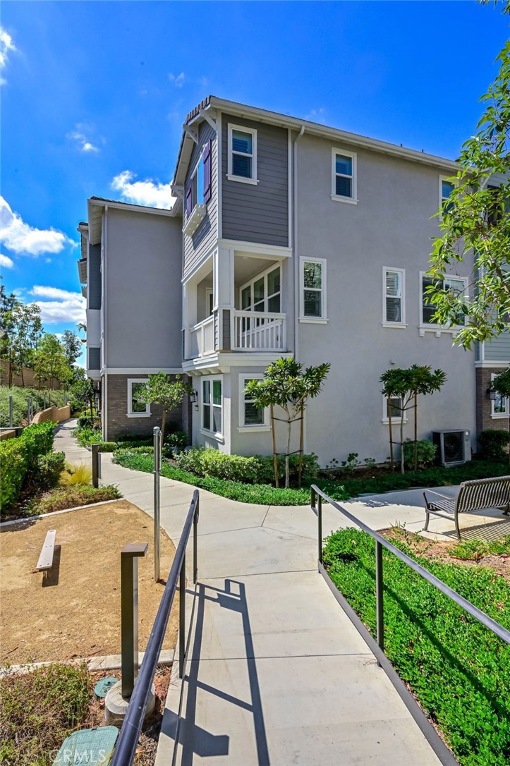 Discover this stunning 4-bedroom contemporary Loma Vista townhome in Yorba Linda, designed with modern living in mind and beautifully enhanced with thoughtful upgrades, including Smart Home features throughout. At the heart of the home, the chef’s kitchen impresses with GE Profile appliances—including refrigerator, gas range, microwave, and dishwasher—granite countertops, a spacious island, and soft-close white cabinetry, flowing seamlessly into the open-concept family room with sliding doors to a private balcony ideal for relaxing or entertaining. A versatile ground-floor bedroom with en-suite bath complements the three additional bedrooms upstairs, including the luxurious primary suite with a generous walk-in closet and spa-inspired bath featuring a dual vanity and walk-in shower. Energy-efficient dual-pane windows with custom shutters, a whole-house fan, tankless water heater, vinyl plank and tile flooring, and an upstairs laundry with stacked washer and dryer add everyday comfort and convenience. Additional highlights include a 2-car attached garage with EV charging options and access to resort-style community amenities such as a sparkling pool, lounge area, and tot lot. Ideally located near the new Yorba Linda Town Center and zoned for top-rated Mabel Paine Elementary, Yorba Linda Middle, and Yorba Linda High, this home perfectly blends style, comfort, and convenience.