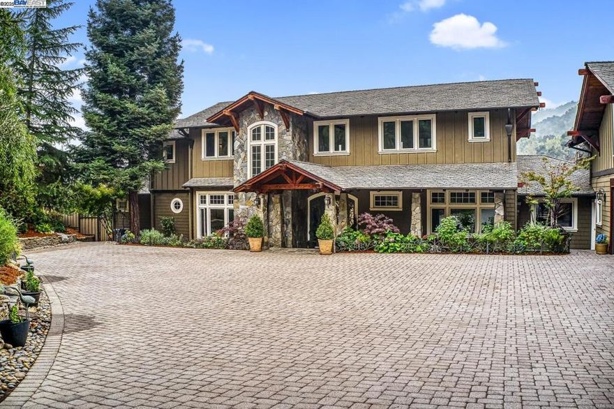 This magnificent high-tech estate is nestled on a perch of 5 acres offering commanding mtn views in the popular Mt Eden Estates of the Saratoga Foothills. Experience unparalleled privacy while only a serene ten min drive to the elite Saratoga schools. This estate offers a multitude of wonderful amenities, including: multiple patios, sizeable garden, vineyard, dog run, mature landscaping, aruba mesh network, and large 4 car garage. Chef's kitchen features stone countertops, center island and top of the line appliances. Graceful transition from indoor to outdoor living featuring a covered veranda, huge patio, fireplace, hot tub and al fresco dining. The main home features 5 bedrooms, 2 offices and 5 & 1/2 baths with a stunning master suite and bath, theater room, game room, grand family room, with skylights with custom bar, soaring ceilings, extensive custom stone and metal work. The estate has 2 additional separate living spaces totaling 1,860 sq ft with 2 bedrooms, an office, 2 full kitchens and baths