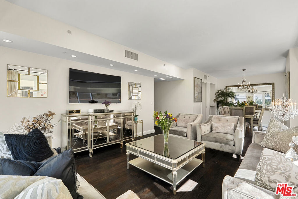 Welcome to The Dorchester on the Wilshire Corridor, one of the most prestigious full-service buildings on the Westside. This beautifully appointed three-bedroom, three full bath residence spans 1,889 square feet and blends timeless sophistication with modern comfort. Situated on a desirable corner, the home is filled with natural light and showcases wide-plank hardwood flooring, creating a warm yet refined atmosphere throughout. The open-concept living and dining areas are ideal for entertaining, complemented by a modern kitchen featuring sleek countertops, stainless-steel appliances, and ample cabinetry. The spacious primary suite offers a serene retreat with a spa-inspired bathroom including dual vanities, a soaking tub, and a glass-enclosed shower. Two additional bedrooms and two full bathrooms provide flexibility for guests, family, or a home office. Residents of The Dorchester enjoy a premier amenity collection: a rooftop pool and sundeck with panoramic city views, BBQ area with pizza oven, state-of-the-art fitness center, infrared sauna, conference room, and elegant lobby with 24-hour security, concierge, and valet service. Perfectly located moments from Beverly Hills, Century City, UCLA, and the best dining and shopping Los Angeles has to offer!