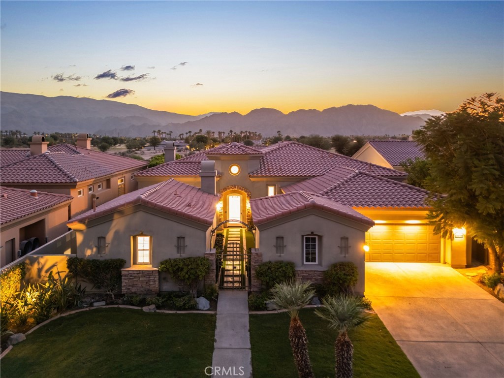 Nestled within the prestigious PGA West community, this exquisite home offers an unparalleled desert lifestyle with breathtaking, unobstructed views of the Santa Rosa Mountains and the 6th fairway of the renowned Greg Norman Golf Course. A private courtyard entrance leads you into this luxurious residence, which boasts an expansive open-concept floor plan perfect for both relaxation and entertaining.
The chef’s kitchen is a true highlight, recently updated with new countertops and equipped with top-of-the-line stainless steel appliances, a double island, a walk-in pantry, and a sunken bar—making it ideal for both culinary enthusiasts and those who enjoy hosting guests. Throughout the home, you’ll find freshly painted interiors, built-in cabinetry, and elegant travertine flooring. The large master suite offers a serene retreat, while the expansive sliding glass doors in the great room provide seamless views of the golf course and surrounding mountains, effortlessly blending indoor and outdoor living.
The backyard is a true oasis, featuring brand-new artificial turf and a saltwater pool with a new Pebble Tec finish. A spa with beach entry, a BBQ area, a firepit, and an outdoor dining space create the perfect setting for enjoying stunning desert sunsets with friends and family.
This home is equipped with smart home automation, including Wi-Fi thermostats, smart door locks, and a mobile app to control the pool and spa, offering both convenience and modern luxury. Offered turnkey furnished, this property combines comfort, style, and technology, making it the perfect choice for anyone seeking an exceptional living experience in one of the most coveted golf course communities in the desert.