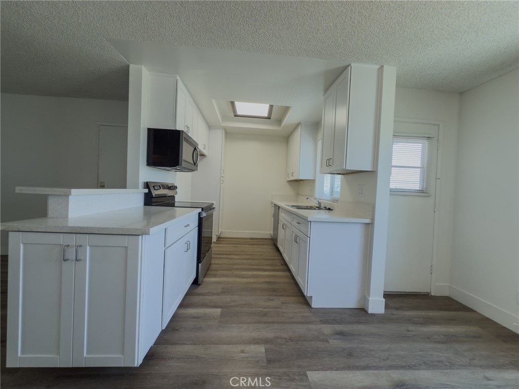 This Immaculate upstairs three-bedroom, two-bath apartment is in a quiet four-unit complex that features Luxury Vinyl plank flooring throughout and new kitchen cabinets with white countertops. The bedrooms have mirrored wardrobe closets, dual-paned windows, and window coverings throughout the unit. The apartment features laundry hookups in the unit and a private two-car garage. It is conveniently located near South Bay Beaches, major shopping areas, and freeways. No pets.