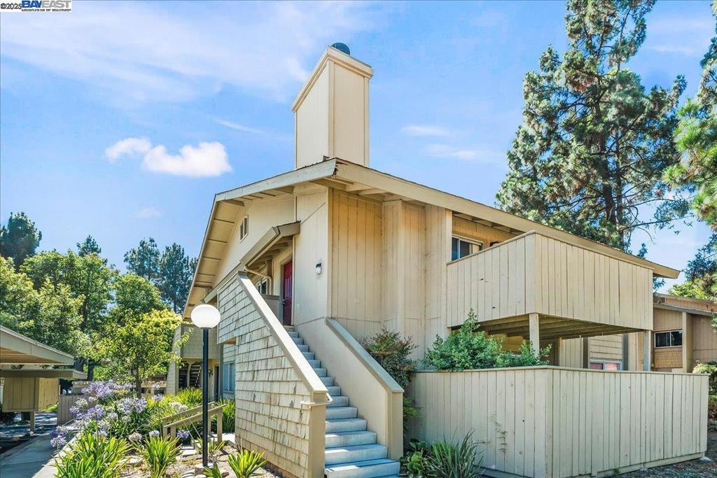 Welcome to Warm Springs! This wonderful home has its own private stairway leading to this upper end unit, complete with a beautiful view of the East Foothills and Mission Peak! Fresh and clean and ready to move in...this beautiful condo has a cozy living room with a wood-burning fireplace, in-unit full size laundry including washer and dryer, two spacious bedrooms, and a separate vanity area for the primary suite! The kitchen is ready for a new cook and includes: new quartz countertops, freshly painted cabinets, new dishwasher, new sink and more...other recent improvements include: new laminate flooring throughout, new bathroom shower/tub enclosure and new interior paint! Relax on your balcony and enjoy the views with coffee in the morning, or maybe a cold beverage in the evening! Two covered parking spaces located just in front of the unit. Parking space is #24. Distinguished Warm Springs & Irvington school attendance areas. Close to Highways 680/880, 237 and Warm Springs BART! Open house this Sat & Sun August 9th & 10th 1-4 pm