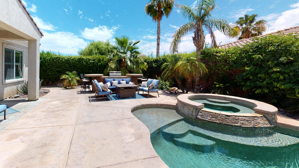 This south facing 3 bedroom/2.5 Bath offers and outdoor paradise. The open floor plan offers extensive title floors, 10' ceilings & a 3-car garage. This is a breakfast nook, bright kitchen with stainless steel appliances and a formal dining area that overlooks the covered patio and lush landscaped backyard. The oversized master suite is well appointed, and the Master bath has been upgrade with dual vanities, large tub, shower & walk-in closet with organizers. The backyard boasts a pebble pool & spa with tanning ledge and outdoor shower. The built-in BBQ & refrigerator are ideal for entertaining. Additional features include shutters, custom fixtures and ceiling fans, and is offered furnished per inventory. The home is adjacent to a greenbelt and situated in the heart of Estacio, a wonderful gated community that also features a community pool. This is the perfect location to enjoy your desert vacation! Home available July-October 2025 @ $3000 per month and November-December @ $4,000 per month. There is a two month minimum!