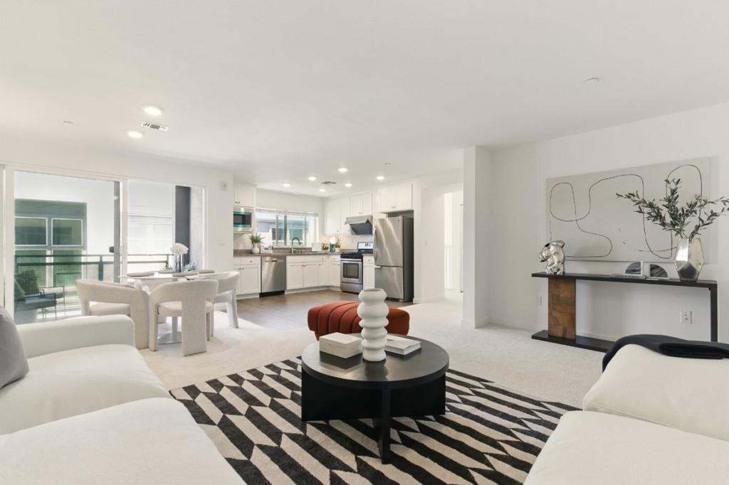 Modern tri-level townhome built by award-winning builder Pulte! This 2 bed, 2 bath home offers 1,391 sq ft of well-designed living space. The main level features an open kitchen with white cabinetry, quartz countertops, stainless steel appliances, and a built-in water filtration system, seamlessly connected to the dining and living areas with laminate flooring. It also includes a spacious primary suite with dual sinks, and walk-in closet, plus a second bedroom and full bath with tub. Fresh interior paint and brand-new carpet throughout the entire home. Additional features include recessed lighting, tile floors in baths, dual-pane windows, central A/C, tankless water heater, and fire sprinklers. Refrigerator and washer/dryer included. Attached 2-car side-by-side garage. Centrally located within the community, this home offers both privacy and easy walking access to the neighborhood park. Low HOA. Close to Berryessa BART, Google shuttle stop, Hwy 101/680/880, and minutes from Costco, Hmart, 99 Ranch, Sprouts, Stratford & Challenger schools.