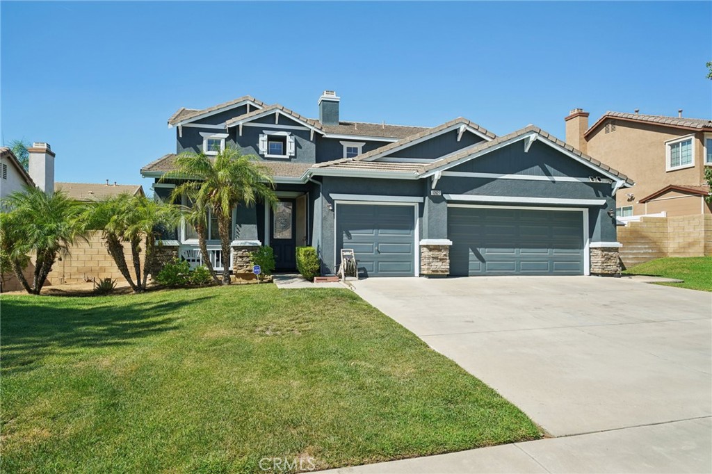 Welcome to this clean and well-maintained home offering spacious living, great natural light, and fantastic curb appeal with its beautiful blue exterior with crisp white trim and lush grassy front yard. Inside, the inviting floorplan begins with formal living and dining areas off the entry, along with a versatile den/office with double doors. Richly hued laminate flooring flows through the main living spaces, with tile in the entry and kitchen and cozy carpeting in the bedrooms. The spacious kitchen features wood cabinetry, a center island, stainless steel appliances, and a sunny breakfast area that opens seamlessly to the family room with a tile-framed fireplace and mantle. A glass slider leads to the backyard patio, perfect for lounging, dining, and barbecues, surrounded by a manicured yard with mature shrubs and grassy space. This home offers a main floor bedroom and full bathroom with shower, as well as a convenient laundry room with abundant storage cabinetry and direct access to the 2-car garage. Upstairs, enjoy a spacious loft, three additional bedrooms, and two full bathrooms. The oversized primary suite boasts a walk-in closet and an en suite bathroom with a soaking tub, shower, and dual-sink vanity. Additional highlights include a leased solar system for energy efficiency and a prime location close to schools, shopping, and the 60 freeway.
