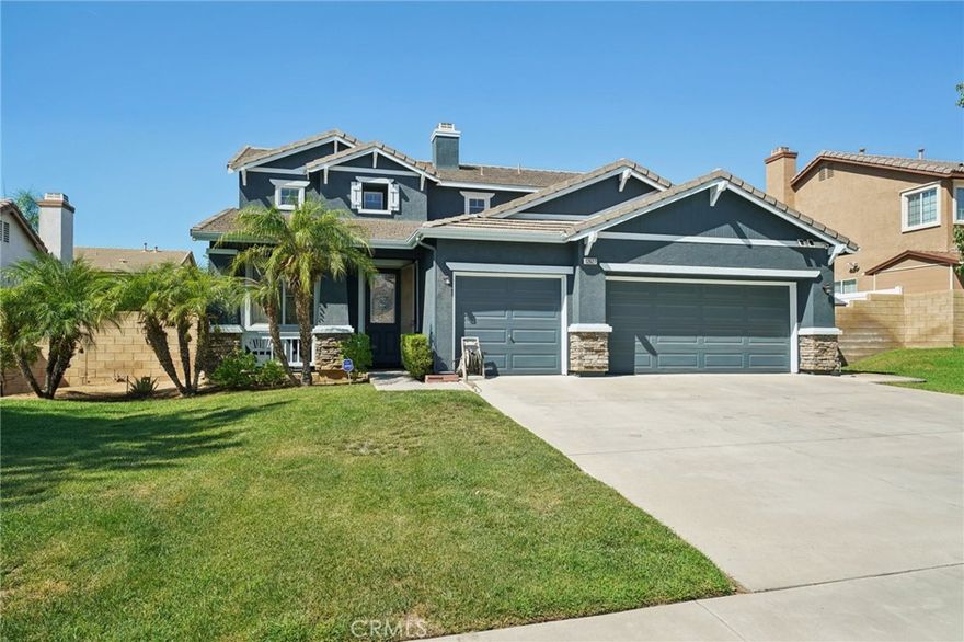 Welcome to this clean and well-maintained home offering spacious living, great natural light, and fantastic curb appeal with its beautiful blue exterior with crisp white trim and lush grassy front yard. Inside, the inviting floorplan begins with formal living and dining areas off the entry, along with a versatile den/office with double doors. Richly hued laminate flooring flows through the main living spaces, with tile in the entry and kitchen and cozy carpeting in the bedrooms. The spacious kitchen features wood cabinetry, a center island, stainless steel appliances, and a sunny breakfast area that opens seamlessly to the family room with a tile-framed fireplace and mantle. A glass slider leads to the backyard patio, perfect for lounging, dining, and barbecues, surrounded by a manicured yard with mature shrubs and grassy space. This home offers a main floor bedroom and full bathroom with shower, as well as a convenient laundry room with abundant storage cabinetry and direct access to the 2-car garage. Upstairs, enjoy a spacious loft, three additional bedrooms, and two full bathrooms. The oversized primary suite boasts a walk-in closet and an en suite bathroom with a soaking tub, shower, and dual-sink vanity. Additional highlights include a leased solar system for energy efficiency and a prime location close to schools, shopping, and the 60 freeway.