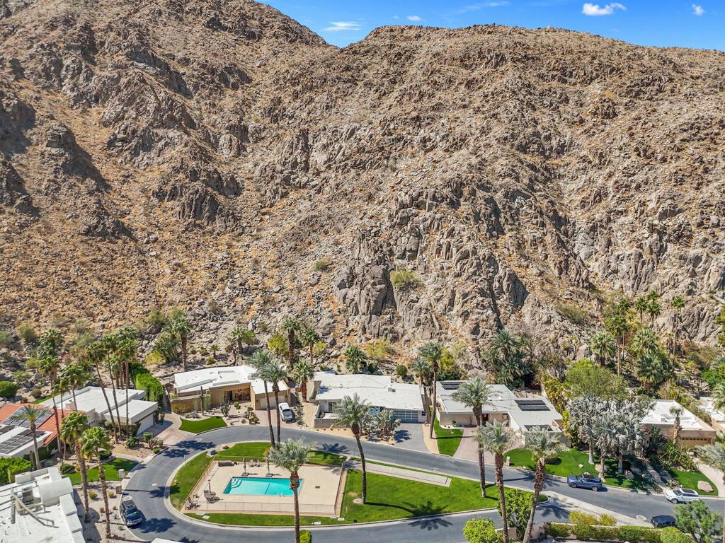 Mid-Century Modern Gem in Historic Indian Wells Country Club - No HOA!Step into timeless elegance with this rare mid-century modern A-frame home nestled in the prestigious Indian Wells Country Club. Located in a quiet cul-de-sac, this historic property is in the neighborhood where Hollywood legends Desi Arnaz and Lucille Ball once resided in the late 1950s. Enjoy the exclusivity of a 24-hour guard-gated communitya'without the burden of HOA fees.This 3-bedroom, 2-bath home is perfectly positioned against the majestic Santa Rosa Mountains, offering stunning panoramic views. The open-concept layout floods the space with natural light, featuring a stylish kitchen that flows into the spacious great room and dining area, all anchored by a cozy fireplace.Designed for privacy, the bedrooms are thoughtfully separated, providing a tranquil retreat for all. Whether you're seeking a full-time residence or a luxurious vacation getaway, this home offers the perfect blend of classic mid-century charm and modern-day comfort.Other key upgrades include new windows, upgraded kitchen, redesigned bathrooms, new AC along with 6 mini splits giving each room temperature control, enclosed sunroom lounge against the mountains, and more!Outside, enjoy direct access to a serene community pool just steps from your front door. A two-car garage adds convenience, while the peaceful, tucked-away location enhances the sense of retreat.An entertainer's dream and a piece of Indian Wells history