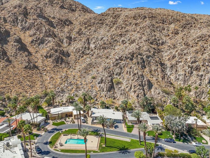 Mid-Century Modern Gem in Historic Indian Wells Country Club - No HOA!Step into timeless elegance with this rare mid-century modern A-frame home nestled in the prestigious Indian Wells Country Club. Located in a quiet cul-de-sac, this historic property is in the neighborhood where Hollywood legends Desi Arnaz and Lucille Ball once resided in the late 1950s. Enjoy the exclusivity of a 24-hour guard-gated communitya'without the burden of HOA fees.This 3-bedroom, 2-bath home is perfectly positioned against the majestic Santa Rosa Mountains, offering stunning panoramic views. The open-concept layout floods the space with natural light, featuring a stylish kitchen that flows into the spacious great room and dining area, all anchored by a cozy fireplace.Designed for privacy, the bedrooms are thoughtfully separated, providing a tranquil retreat for all. Whether you're seeking a full-time residence or a luxurious vacation getaway, this home offers the perfect blend of classic mid-century charm and modern-day comfort.Other key upgrades include new windows, upgraded kitchen, redesigned bathrooms, new AC along with 6 mini splits giving each room temperature control, enclosed sunroom lounge against the mountains, and more!Outside, enjoy direct access to a serene community pool just steps from your front door. A two-car garage adds convenience, while the peaceful, tucked-away location enhances the sense of retreat.An entertainer's dream and a piece of Indian Wells history