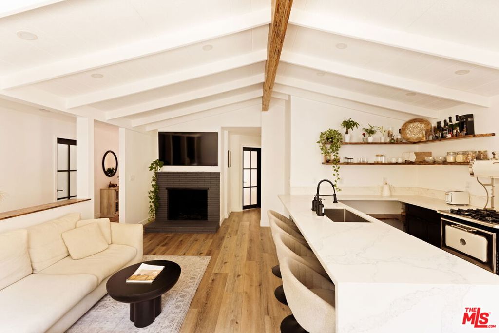 Nestled in prestigious Laurel Canyon, this fully remodeled home combines style, luxury, and comfort. Rare at this price point, it offers 3 bedrooms, 2 full bathrooms, and 3 parking spaces including a private 2-car garage. A versatile first-floor bonus room adapts to your needs perfect as a media room, home gym, office, art studio, or playroom. The main living area features an open floor plan with vaulted ceilings and a kitchen ideal for entertaining. Step outside to a private backyard with a serene patio for al fresco dining and gatherings. Located in the highly regarded Wonderland School District, this home is truly one-of-a-kind.