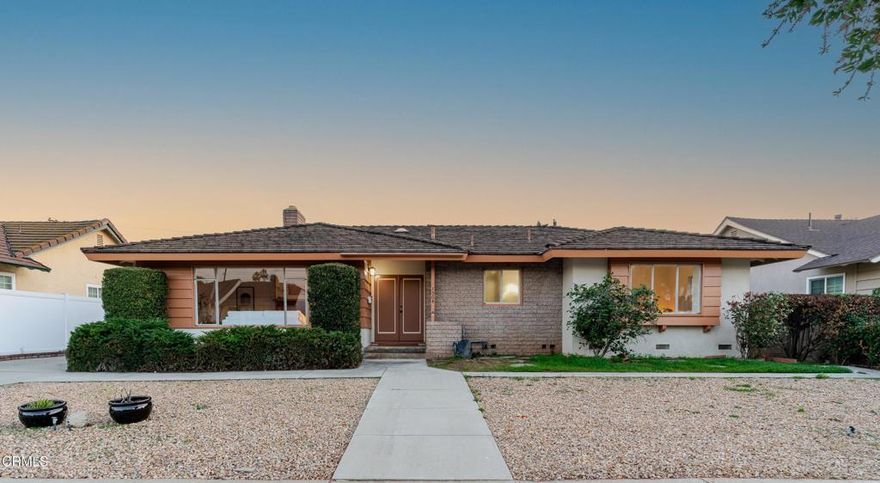 Filled with original mid-century charm, this 5-bed, 3-bath home is located in a highly desirable Covina neighborhood, and is ready for its next owner. The appeal starts at the curb with drought-tolerant landscaping and a prime mid-block location. Step inside to the formal living room with a cozy brick fireplace and large picture window. Just beyond, the formal dining room with a second fireplace, wood-beamed ceiling, and period light fixture, serves as the heart of the home, connecting seamlessly to both the kitchen and the den. The den provides a flexible space perfect for a secondary living area, home gym, or studio, with direct access to the backyard. The kitchen offers wonderful potential, complete with a breakfast area, built-in double ovens, charming wood trim, tile counters, and a walk-in pantry. The nearby powder room and laundry hookups add convenience. The first bedroom sits on this side of the home with private patio access, an ideal setup for a home office or guest suite. The east wing holds three additional guest bedrooms and the primary suite, tucked at the end of the hall, provides a peaceful retreat with sliding doors that open to the backyard. Outside, a spacious patio is perfect for dining al fresco or relaxing in the California sunshine, and the yard has ample room to garden, play, or entertain. With generous living spaces, a flexible layout, and a fantastic location close to schools, parks, & shopping, this house is ready to be transformed into your home!