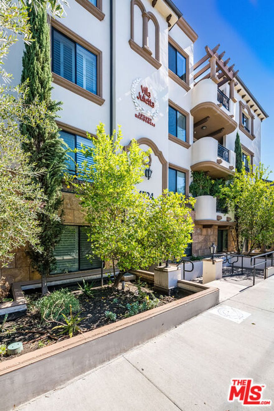 Stunning unit in a newer, luxury building. Freshly painted and bathed in natural light with an open and spacious floor plan, it is located close to Ventura Blvd shops & restaurants. The upscale finishes include engineered wood flooring, wood blinds, recessed lighting & natural stone finishes. The open and bright kitchen has granite counters, stainless appliances & a breakfast bar. A large living room with multiple seating areas has a fireplace, private balcony & an open concept into dining area, perfect for entertaining! The master bedroom has a large walk-in closet, balcony access, & a luxurious bathroom with natural stone counters, over sized shower & dual vanities. The secondary bedroom is on the opposite side away from the master. In unit laundry completes this beautiful interior. The "Villa Julietta" with Tuscan inspired architecture, offers a gym, sauna, rec room, a sun deck, 2 gated parking spaces & guest parking. HOA includes EQ insurance.