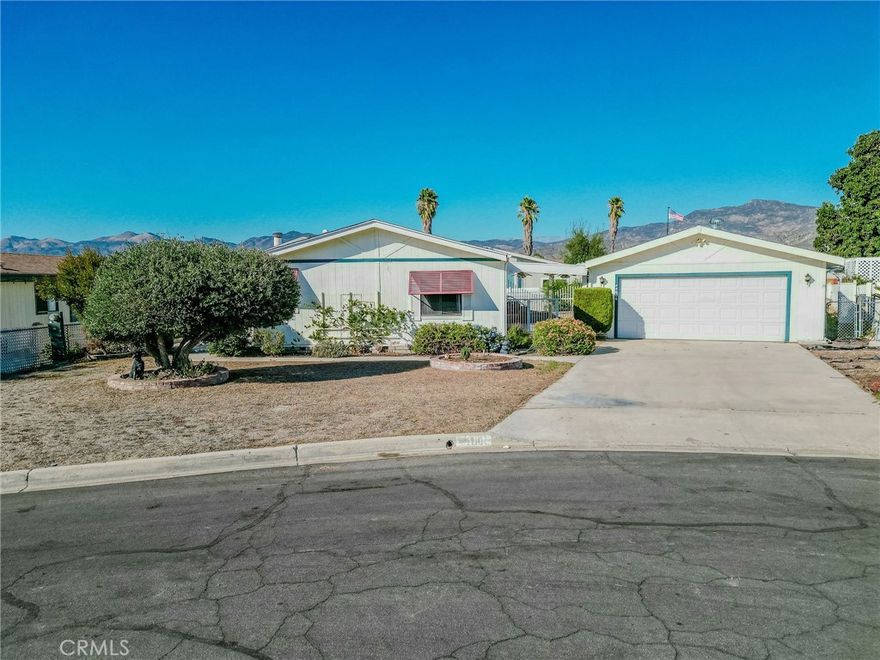 Welcome to this well-maintained 3-bedroom, 2-bath triple-wide home, ideally located at the end of a peaceful cul-de-sac. With 1,602 sq. ft. of open living space, this property offers comfort, privacy, and everyday convenience.



A covered patio entry welcomes you into the bright, open layout featuring custom cabinetry throughout, ceiling fans, and warm-toned wood flooring for a cohesive, inviting feel. The kitchen showcases granite countertops, ample storage, and a double sink overlooking the front yard—perfect for natural light and curbside views.



The spacious primary suite includes a walk-in closet and a private bath with elegant tilework and rich cabinetry. The laundry room is thoughtfully designed with cabinetry, a utility sink, and direct access to the patio and detached 2-car garage, making daily living effortless.



Out back, enjoy a large covered patio for outdoor dining or relaxation, and a spacious fenced yard with plenty of room for pets, gardening, or future improvements. Close to shopping, dining, and local conveniences, this move-in-ready home blends quiet cul-de-sac living with practical comfort and charm.