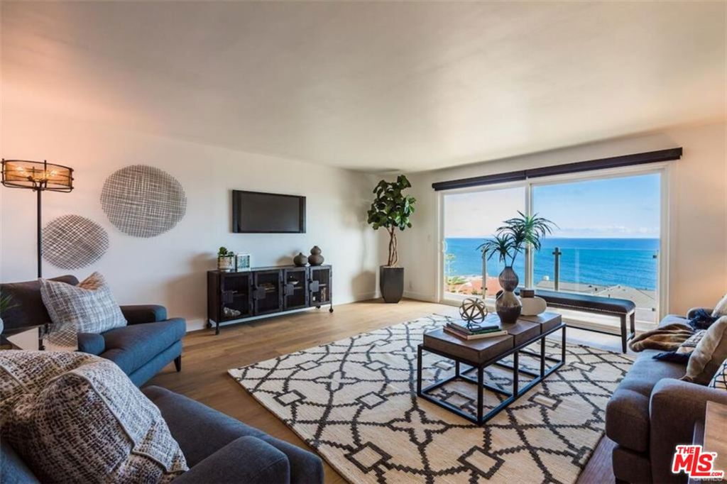 Stunning modern view property! This is your chance to live in Malibu off Coastline Drive with sweeping, stunning views of the Pacific Ocean and the Queen's Necklace. 180 degree panoramic views from the balcony and master bedroom of the Villa de Leon, Santa Monica, Malibu, the ocean and the beaches. This 2BD/2BA is very open, offers plenty of great natural light and flows smoothly throughout. French oak floors line the entire unit with freshly updated tiled bathroom floors. Oversized white quartz kitchen counters and newer stainless-steel appliances, open to the dining area making it perfect for entertaining. Newer kitchen cabinets along with new hardware. Newer windows and sunken living room slider, built-in closets in both bedrooms and the washer/dryer has been brought into the unit! This property will not last! Just minutes to Santa Monica, Malibu and the city! A short walk over to the Getty Villa or across the street and your toes are in the sand! This is your chance to live in Malibu and wake up every day to some of the best views around!