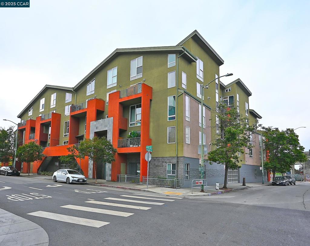 This contemporary top floor loft is perfect for city living! The open floor plan is enhanced by large windows, allowing for an abundance of natural light. Polished cement floors, high ceilings, stainless-steel appliances, two full baths, in-unit laundry and a beautiful fireplace. Adjacent to the living room, there is an office with stowaway queen size Murphy bed that doubles as a second bedroom, providing flexibility for buyers who work from home or need a second bedroom. The loft also boasts a generous balcony with city views, perfect for enjoying the outdoors. Additionally, the unit includes one dedicated parking space and an extra storage closet, ensuring ample room for belongings. Perfectly situated for commuters, this loft offers easy access to freeways, the BART station, and the Ferry Terminal, making commuting to San Francisco a breeze. Enjoy the convenience of nearby shopping, dining, and entertainment options. Located just minutes away from downtown Oakland, Uptown, and the vibrant Jack London Square! Walk score of 96!