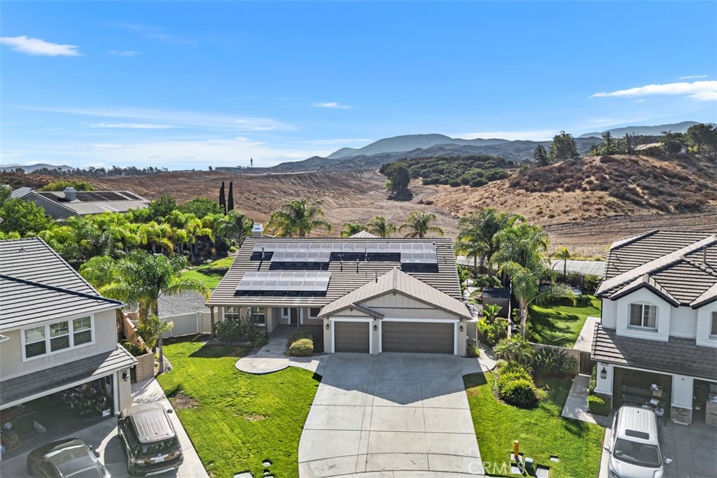 Welcome to this one-of-a-kind Morgan Valley cul-de-sac home, set on over a ½-acre lot with RV parking, no rear neighbors, and a resort-style saltwater pool and spa.
This spacious home offers 4 bedrooms, an office, and a large bonus room, with a highly desirable floor plan that lives like a single story. The downstairs features the primary suite, an additional bedroom with full bath, a guest bathroom, and a private office with built-in desk/workspace. Formal living and dining rooms are centered around a beautiful dual-sided fireplace, while the open family room flows into a chef’s kitchen complete with granite counters, full backsplash, stainless steel appliances (including built-in refrigerator), center island with bar seating, walk-in pantry, and butler’s station with wine fridge.
Upstairs, you’ll find two oversized bedrooms, a full bath, and a large bonus room with balcony.
The backyard is truly an entertainer’s dream, featuring a rock pool and spa with waterfalls, two built-in fire pits, and a fully equipped outdoor kitchen with stainless steel BBQ, fridge, sink, two TVs, outdoor speakers, and bar seating.
Additional highlights include a 3-car garage with epoxy flooring, built-in storage and workbench, a whole-house water softening system, crown molding, plantation shutters, and beautiful tile throughout the main living areas. The stunning views provide the perfect backdrop to this rare property.
Located just minutes from Temecula’s best shopping, dining, and wineries, and within the highly rated Great Oak High School boundaries.