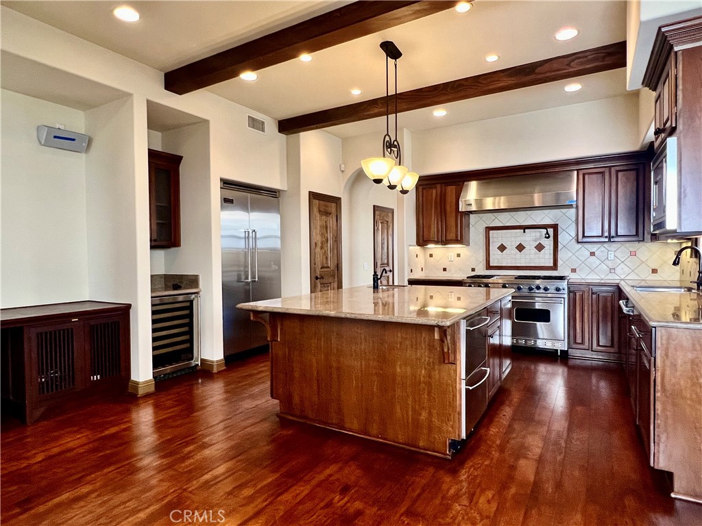 Just two blocks from the sand sits this beautiful mediterranean home that has been masterly designed to offer old world charm with modern conveniences. The three stories home boast over 2800 sq feet of living space which includes 3 bedrooms, 5 bathrooms , a formal living room, a spectacular high ceiling family room retreat, and a recreational room that can be used as a 4th bedroom with an en-suite and a large lookout balcony. You can also enjoy entertaining your guests in the expansive gourmet kitchen that includes and extra large granite island and all high end appliances. Home also features three beautiful fireplaces, built in cabinets, central vacuum, central A/C , surround sound system throughout the house and many more. Best of all, you will appreciate the low monthly electric bill you get from the solar panels. Come and call this luxurious house your home in the vibrant city of Huntington Beach.