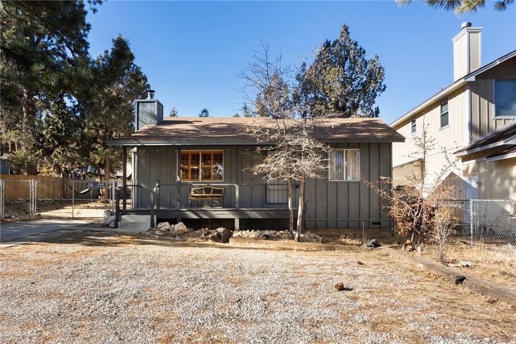Welcome to this charming mountain cabin in the heart of Sugarloaf! This well-maintained home features an open-concept living area with warm pine ceilings, a wood-burning stove with classic brick surround, and a spacious kitchen with a breakfast bar and adjacent dining area—ideal for entertaining. Additional highlights include a gas wall heater, dedicated laundry room, and a large attic space offering ample storage. The property sits on a level, fully fenced 75x100 lot with mature trees and easy year-round access. Two sizable storage sheds provide even more functional space. Relax and take in the serene setting from the covered front porch—perfect for enjoying the fresh mountain air. Furnishings are negotiable. An excellent opportunity for a full-time residence, weekend getaway, or investment property. Also available for lease at $2,200/month—rental applicants welcome.