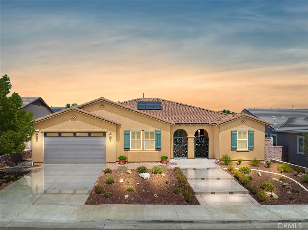 RARE FIND Stunning and immaculate nearly 2900 sq ft single story home in the desired community of Mahogany Hills. This property is a must see! This home begins with marvelous curb appeal with lighted custom walkway and custom gated double-archway front entry with a private porch. This lovely gem warmly and impressively greets even the pickiest of buyers. Beautifully upgraded home has an open concept floor plan with beautiful tile wood plank look flooring, upgraded baseboards as well as crown moulding in many rooms. The warm neutral tones, upgraded light fixtures and ceiling fans create an exceptionally warm and peaceful ambiance. The entertainer's dream kitchen has an oversized island, breakfast nook, white cabinetry with handles/pulls, butler's pantry plus walk-in pantry, granite counters, stainless steel appliances and tons of storage. There is a large separate dining room. The generously sized great room includes a fireplace ideal for enjoying our chilly winter evenings and is open to the kitchen for entertaining. The spacious primary suite off its own wing of the house has its own retreat area perfect for morning coffee and evening movies. The primary bath has an upgraded soaking tub, walk-in shower, dual vanity, glass tile design with bronze fixtures and a large walk-in closet. There is also a junior suite at the opposite end of the home offering guests their own bathroom, walk-in closet, and complete privacy. There are 2 additional bedrooms with their own dual vanity bathroom. One of the 4 bedrooms has beautiful built-in cabinets for a home office. Perfect for someone that works from home and needs a nice office, but can also be a bedroom if desired. Huge laundry room with sink and lots of storage. The backyard allows for plenty of relaxation. Beautiful Alumawood patio cover along with LOW MAINTENANCE LANDSCAPING. There's even a mountain view from the side and front. 3-CAR TANDEM GARAGE with epoxy coated flooring. 6 PAID SOLAR PANELS! Close proximity to community park, walking trails and top-rated Lisa J Mails elementary school. Call to tour this amazing property today!