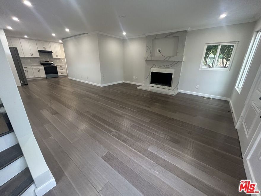 A beautifully updated three-bedroom, two-bathroom home is available for rent in North Hollywood, offering approximately 1,400 sq. ft. of thoughtfully designed living space. The interior features an open and inviting layout with contemporary finishes, recessed lighting, and elegant flooring throughout. The spacious living area includes a modern fireplace and seamlessly flows into the upgraded kitchen, which is equipped with stainless steel appliances, extensive cabinetry, and sleek countertops.The home offers well-proportioned bedrooms and stylishly renovated bathrooms, providing comfort and functionality for everyday living. Outdoors, residents can enjoy a well-maintained yard with mature landscaping and a clean, modern aesthetic, creating an ideal environment for relaxation or entertaining. The property includes gated parking for one car, adding an extra layer of security and convenience.Located in a desirable North Hollywood neighborhood, this residence combines modern upgrades with a peaceful setting. Tenant is responsible only for electricity.