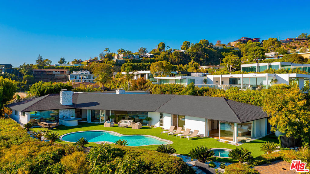 Views Views Views! Discover luxury in this beautifully remodeled and designed Trousdale retreat. This stunning property features sweeping views that span from downtown to the ocean. Offering 7 bed/6 bath with 5,200 sqft of living space along with an incredible indoor/outdoor flow that complements the ultimate California dream living. The interior composition harvests a sense of style & elegance w/ features like engineered hardwood, gourmet chef's kitchen, wall to wall glass, 2 fireplaces and panoramic views that encase the entire living area. The backyard oasis offers an alluring private pool and spa on nearly half an acre of land. This gem was constructed with the finest materials and is nestled serenely on one of the quietest and most desirable streets in Trousdale.