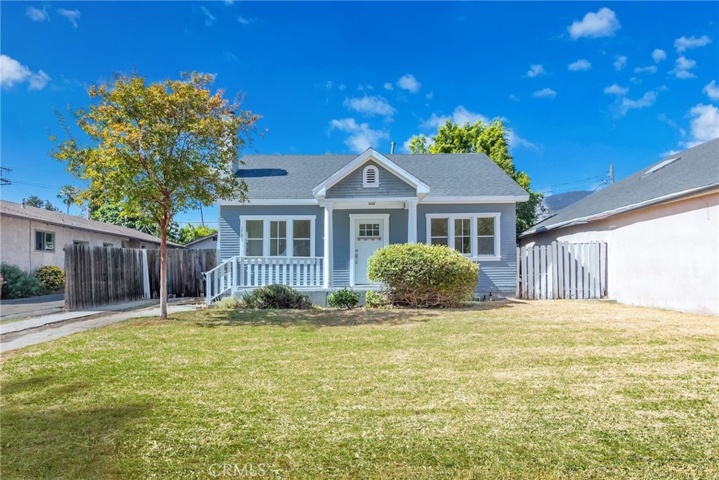 This one-story, south-facing California Bungalow is located in the NE Pasadena neighborhood. A charming covered front porch welcomes you, while the large front yard and long driveway—able to fit multiple cars, lead to a detached rear garage.
Minutes from schools, supermarkets, shops, and public transportation, the home is also close to Old Town Pasadena, The Shops on Lake Avenue, Hastings Ranch, and Rose Bowl Stadium. Outdoor enthusiasts will enjoy nearby Victory Park, hiking trails, and golf course.
Inside, the layout offers a living room, kitchen, dining area, three bedrooms, two bathrooms, and a laundry room. Features include central A/C and heating, recessed lighting, hardwood floors, newer laminated wood, and ceiling fans.
The bright living room boasts a decoratively painted white brick fireplace, built-in bookshelves, and hardwood floors. The kitchen offers cherry-stained cabinetry, crystal white quartz countertops, a mosaic backsplash, slate flooring, and a center island. The dining area is ideal for everyday meals or gatherings, with the laundry room nearby.
Two bedrooms share a Jack & Jill bathroom, while the third bedroom has modern gray flooring, backyard views, and an ensuite bath. Large windows throughout fill the home with light.
The private backyard is framed by mature greenery and fruit trees, with mountain views and sunset backdrops. There’s ample space for entertaining, gardening, or alfresco dining—an inviting place to create lasting memories.