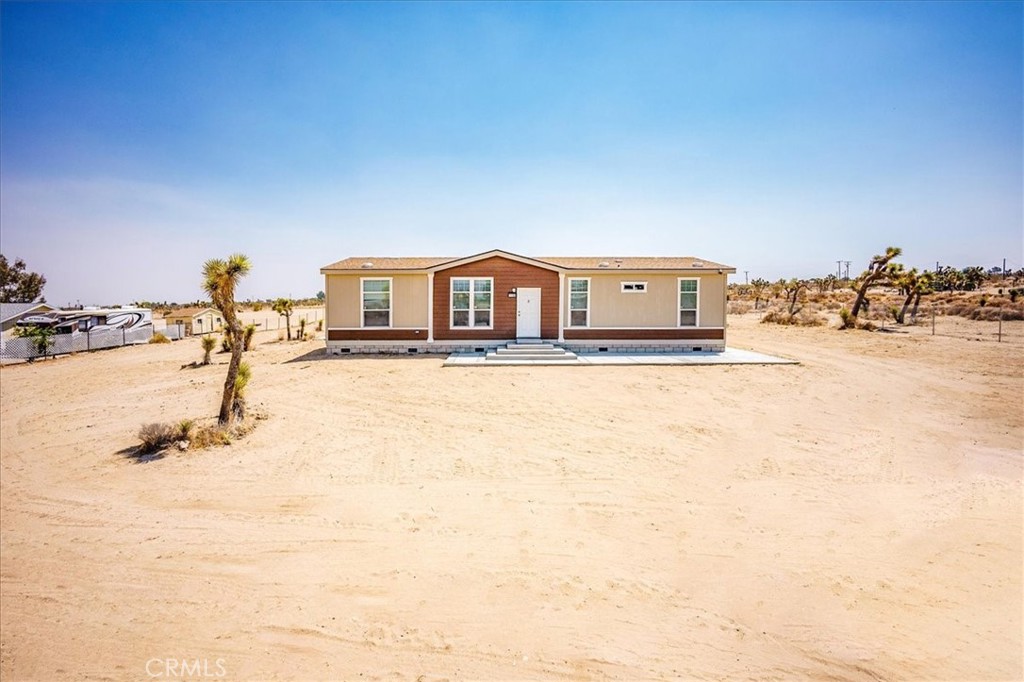 Welcome to 11354 Buena Vista Dr, Phelan, CA 92371 — a beautifully updated 3-bedroom, 2-bathroom home set on 2.41 fully fenced acres, offering the perfect blend of privacy, space, and breathtaking desert and mountain views. Located just off a paved road and minutes from local amenities, this property provides rural charm with modern convenience. Step inside and discover a thoughtfully designed home tailored for both comfort and functionality. The spacious kitchen boasts stainless steel appliances, modern cabinetry, and generous counter space—ideal for home cooking and entertaining. The open-concept living and dining areas are perfect for gatherings, while a new HVAC system ensures year-round comfort throughout the home. Each of the four bedrooms offers a peaceful retreat, with the primary suite featuring a spacious layout, a walk-in closet, and a stylish bathroom with modern finishes. Both bathrooms are tastefully updated to reflect contemporary design. Love the outdoors? The expansive lot provides endless opportunities—whether you're dreaming of building a workshop, setting up horse facilities, starting a garden, or simply enjoying the vast open space for recreational use or RV parking. Don’t miss your chance to own this desert oasis where you can enjoy starry nights, wide-open skies, and room to grow. Make 11354 Buena Vista Dr your new home today!