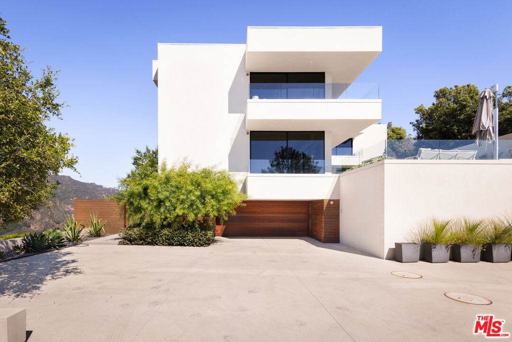 Introducing "The Briarbluff Estate" - Where Timeless Architecture Meets Modern Grandeur- Originally envisioned by the iconic architectural trio Buff, Smith & Hensman in the 1970s, this residence has transcended time through an extraordinary metamorphosis. The visionary touch of renowned architect David Montalba Architects, Santa Monica, has meticulously transformed the dwelling from a vertical structure into a harmonious horizontal haven, forging a connection with its surroundings that is both profound and immersive. Spanning a generous 4,788 square feet, the residence exudes an air of refined elegance and contemporary opulence. As you step through its grand entrance, you are greeted by a symphony of indigenous landscape, masterfully integrated through terraced wood-clad walls that carve out enchanting outdoor sanctuaries. Each turn reveals a new panorama, where canyon breezes dance through floor-to-ceiling windows, capturing the mesmerizing interplay of light and shadow. The heart of the home boasts a captivating interplay of textures - from the rugged allure of unique stone to the rich warmth of Brazilian walnut floors. Built-in walnut millwork adds an artisanal touch, crafting an ambiance of both comfort and sophistication. An interior water feature, clad in stone, stands as a living sculpture, infusing the air with tranquil murmurs that harmonize with the surrounding nature. One of the estate's most captivating features is the bespoke aquarium room divider, a true testament to the fusion of art and architecture. This aquatic masterpiece separates spaces while allowing a seamless flow of light, color, and aquatic motion, embodying the spirit of both ocean and innovation. "The Briarbluff Estate" is more than a residence; it's a testament to the confluence of architectural history and contemporary brilliance. This is a home where the past embraces the present, and where the land's whispers intertwine with the pulse of modern luxury. It's a sanctuary where every detail has been thoughtfully curated to elevate life to an art form. Welcome to a realm where architectural heritage meets the pinnacle of modern luxury - welcome to "The Briarbluff Estate" at 21900 Briarbluff Dr., Malibu. Discover a symphony of design, nature, and innovation, and prepare to embark on a journey of boundless inspiration and timeless beauty.