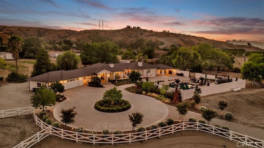 Welcome to the home of your dreams! This one of one modern farmhouse estate offers a luxurious lifestyle with capabilities of work and play.  The long tree-lined paver entrance leads up to a resort like circular driveway.  Walk up the steps to a large covered front porch that wraps around to one of many outdoor sitting areas, a perfect place to soak in the sunrise and mountain views.  Enter the home into the dramatic formal entry with custom ceiling woodwork.  As you walk into the magazine ready family room, you will immediately appreciate the 10’ tray ceiling with real wood beams, the natural lighting, and the views from the outdoor space. The natural gas fireplace wall is a beautiful focal point and cozy winter space. The expansive kitchen with 10’ island, cabinets stacked to the ceiling, 60" gourmet range, and two dishwashers is a chef's dream.  A separate beverage bar and large walk-in pantry offer lots of storage and useful space. Eat breakfast at your eat-in nook, but enjoy dinner with company in the large formal dining room which boast full height accent paneling and spectacular mountain views.  Across the dining area and behind double glass doors is the home office with monitor showing images of the outdoor security cameras.  This home features plenty of space offering 5 bedrooms and 4 full bathrooms, plus 2 half-baths, including an outdoor pool bath. The master bedroom is resort-like with tall open beam wood ceilings, wood burning fireplace, & a bathroom that will bring true relaxation & serenity.  At the opposite end of the home is a 400 SF recreation room with built-in electric fireplace wall and 10’ patio door leading to another outdoor sitting area.  Between the living room and garage is a bonus space, currently being used as a gym, but has many other possible uses.  The outdoor patio space & large pool is expansive and an exceptional space to host large parties.  The 4-acre property is fully fenced and cross fenced with 3 separate gates and includes a horse pasture and 2 horse corals.  This home was completely gutted and remodeled with addition in 2019. Roof is a 50 year shingle.  Electric panel is 400 amps.  Water is on well & has all been gone through with new pump motors and addition of 10,000 gallons of storage.  There are 2 tankless water heaters and two heat/air systems all redone in 2019. If you are looking to get out of the city and finally live in the home you have been dreaming of, don't miss this opportunity.